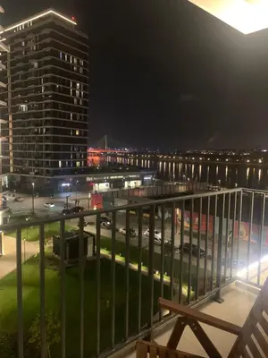 a view of a city at night from a balcony at BW Premium 5th Symphony in Belgrade