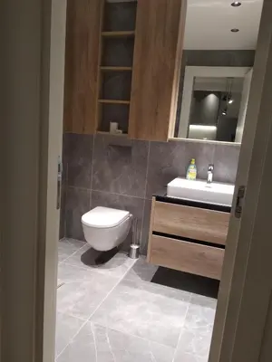 a bathroom with a toilet and a sink at BW Premium 5th Symphony in Belgrade
