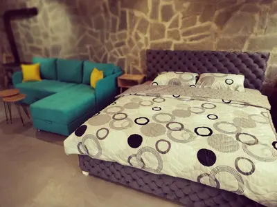 a bedroom with a bed and a couch at Imanje in Arandjelovac