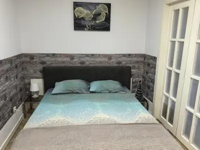 a bedroom with a bed with a brick wall at Belgrade Cozy Apartment - City center in Belgrade
