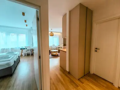 a room with a bed and a room with a living room at Sweet House Skadar Lux in Belgrade