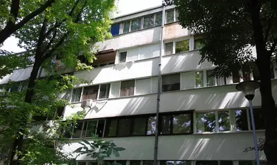 a building with windows and trees in front of it at Apartment Daca Stan na dan in Belgrade