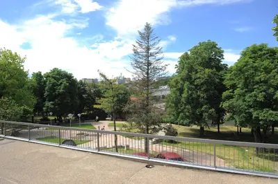 a view of a park with trees and a fence at Apartment Daca Stan na dan in Belgrade