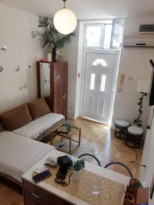 a living room with a couch and a door at Small low cost studio in Belgrade