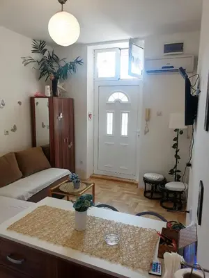 a living room with a couch and a door at Small low cost studio in Belgrade