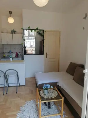 a living room with a couch and a table at Small low cost studio in Belgrade