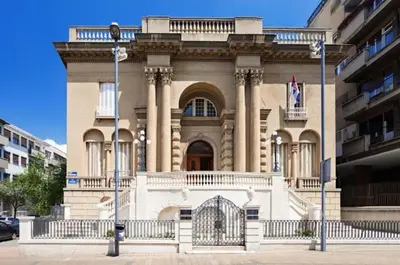 a large building with a gate in front of it at Slavija Lux! 2 Bedroom Apartment city center in Belgrade