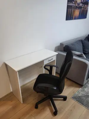 a desk and a chair in a room with a couch at Slavija Lux! 2 Bedroom Apartment city center in Belgrade