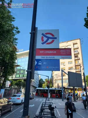 a sign on a pole in a street with cars at Slavija Lux! 2 Bedroom Apartment city center in Belgrade