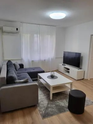 a living room with a couch and a table at Slavija Lux! 2 Bedroom Apartment city center in Belgrade