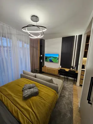 a bedroom with a bed with a yellow blanket at Dimiant Lux River BW in Sajmište