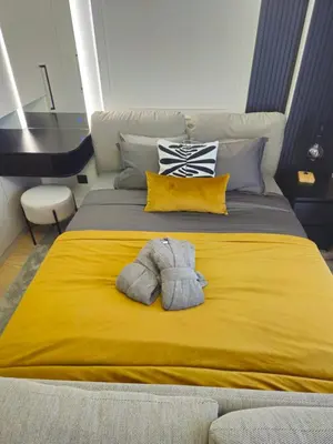 a yellow bed with a stuffed animal on it at Dimiant Lux River BW in Sajmište