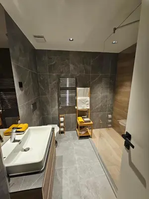 a bathroom with a sink and a shower at Dimiant Lux River BW in Sajmište