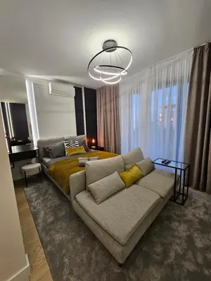 a living room with a couch and a bed at Dimiant Lux River BW in Sajmište
