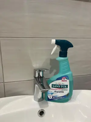 a bottle of sanitizer sitting on top of a sink at Lenny apartman in Belgrade