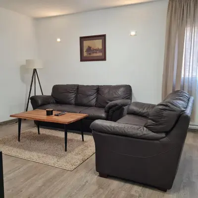 a living room with a leather couch and a coffee table at APARTMAN011 in Mirijevo