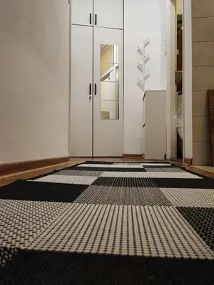 a hallway with a black and white floor at Parlament City Center in Belgrade