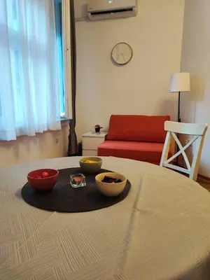 a table with bowls of food on a table with a couch at Parlament City Center in Belgrade