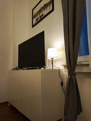 a television on top of a dresser with a lamp at Parlament City Center in Belgrade