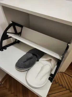 a pair of flip flops and a pair of shoes in a drawer at Parlament City Center in Belgrade