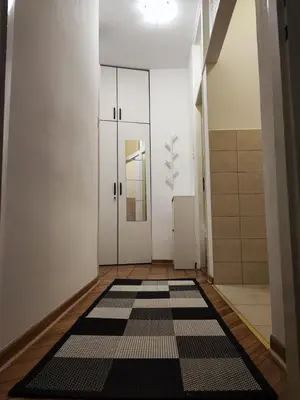 a hallway with a black and white rug on the floor at Parlament City Center in Belgrade