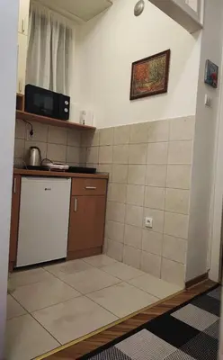 a small kitchen with a sink and a microwave at Parlament City Center in Belgrade