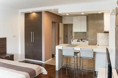 a kitchen with a bar and some chairs in a room at KAN Suites 1 in Belgrade