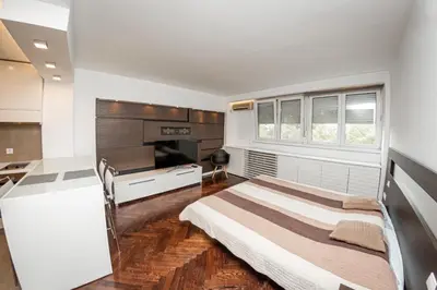 a bedroom with a bed and a desk in it at KAN Suites 1 in Belgrade