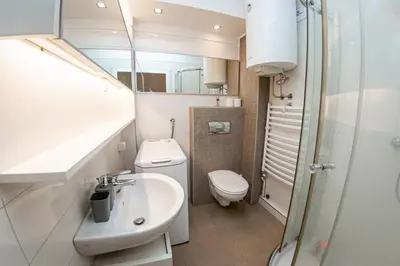 a small bathroom with a sink and a toilet at KAN Suites 1 in Belgrade