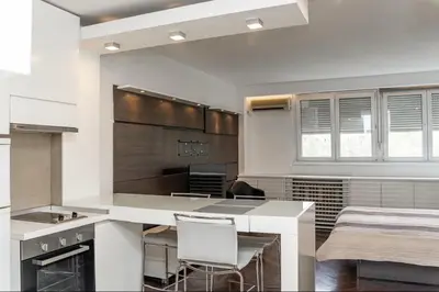 a kitchen with a table and chairs in a room at KAN Suites 1 in Belgrade