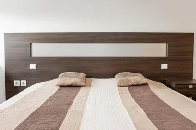 a bedroom with a large bed with two pillows on it at KAN Suites 1 in Belgrade