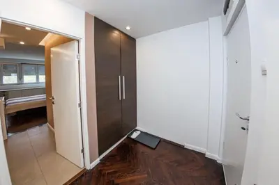 a hallway with a door with a scale on the floor at KAN Suites 1 in Belgrade