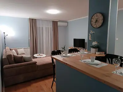 a living room with a couch and a table at Apartman Jela in Borča