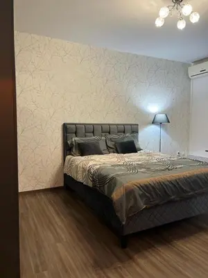 a bedroom with a bed and a wall at Apartman Felix in Zvezdara