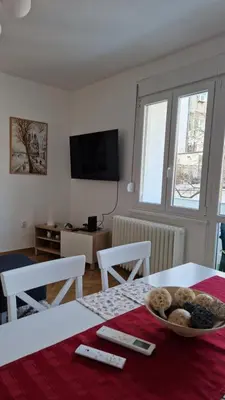 a living room with a table with a bowl of food on it at CashIN apartment in Belgrade