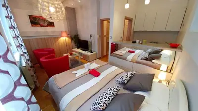 a room with two beds in a room with a kitchen at Atos in Novi Beograd