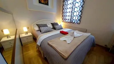 a bedroom with a large bed with two night stands at Atos in Novi Beograd