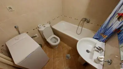 a bathroom with a toilet and a sink and a tub at Atos in Novi Beograd