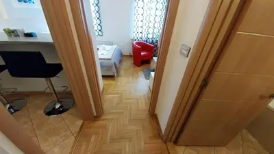 a hallway with a room with a desk and a chair at Atos in Novi Beograd