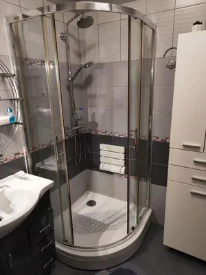a shower with a glass door in a bathroom at Stadion apartman in Belgrade