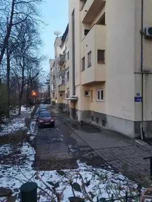 a car parked on a street next to buildings at Stadion apartman in Belgrade