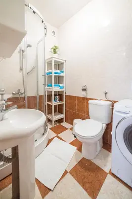 a bathroom with a toilet and a sink and a shower at Panorama Central - Vračar Apartment in Belgrade