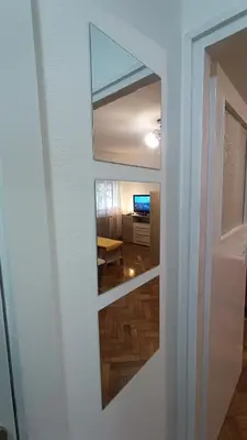 a view of a room through a door with a mirror at Kraljevica Marka Apartman in Belgrade
