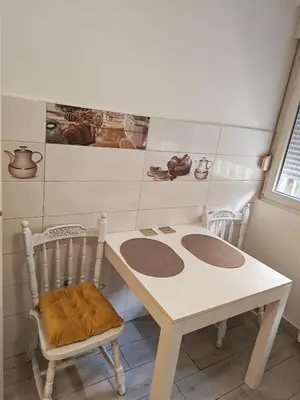 a white table and chair in a room at Kraljevica Marka Apartman in Belgrade