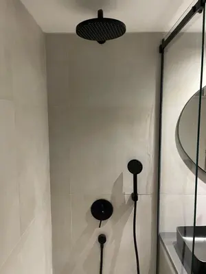 a shower with two black objects on the wall at Green Place in Vračar (historical)