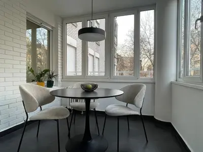 a dining room with a table and chairs and windows at Green Place in Vračar (historical)