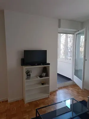 a living room with a flat screen tv on a shelf at Green Place in Vračar (historical)