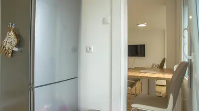 a room with a table and a desk with a chair at Premium stan Novi Beograd in Novi Beograd