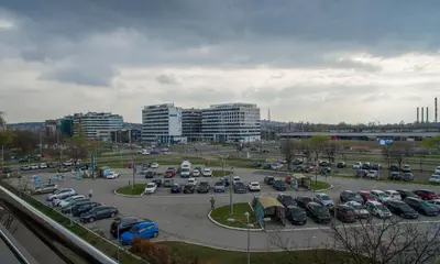 a parking lot with parked cars in a city at Premium stan Novi Beograd in Novi Beograd