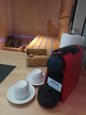 a coffee maker and two cups on a table at Lux studio sa saunom Ampelitsi in Ledine